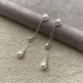 Elegant teardrop tassel pearl earrings in silver finish for a minimalist chic look. - Waterdrop Tassel Stud (HE35573-1) / Silver & White (Silver Earring Post)