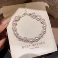 Elegant French retro pearl bracelet with rhinestone paw charms shown on a gift pouch. - Sparkling Rhinestone Cat Paw Style (48#) / Silver