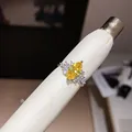 Close-up of a marquise-cut yellow zircon ring on a white leather display tool - Open Ring / Silver-Yellow