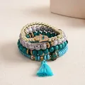 Detailed view of a four-piece beaded bracelet set featuring a crystal-inlaid Hamsa hand - Four-Piece Set / Blue