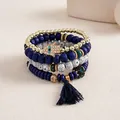 Close-up of Bohemian 4-piece stacked beaded bracelet set with Hamsa hand and tassel. - Four-Piece Set / Dark Blue