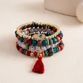 Close-up of 4pcs bohemian beaded bracelets featuring Hamsa hand charm and red tassel. - Four-Piece Set / Red