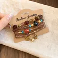 Close-up of Bohemian beaded bracelets with heart, owl, and Eiffel Tower charm details - 3# Heart Eiffel Tower Owl 4-Piece Set / Set of 4 / Gold-Light Coffee