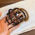 Close-up of bohemian multilayer beaded bracelets with wood beads and tree of life charm - Round Decor (11#) / Brown