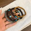 Close-up detail of Bohemian layered beaded bracelets with natural wood and turquoise accents. - Round Style (27#) / Brown-Coffee-Grey