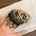 Bohemian ethnic style layered bracelet set with feather charm and colorful wooden beads on hand - Feather Style (4#) / Coffee-Green-Silver