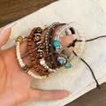 Detailed close-up showing Bohemian multilayered beaded bracelet set with ethnic turquoise charms - Feather Charm Style (16#) / Silver-Coffee-Orange