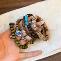 Detailed close-up view of Bohemian multi-layer beaded bracelets with evil eye charm - Evil Eye Charm (3#) / Brown-Green