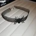 Close-up detail view of a black mesh Halloween spider choker necklace on a display tray - Spider Pendant Choker