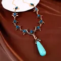 Prachtige vintage boho ketting met blauwe edelstenen en grote turquoise hanger. - Ketting-Antiekgoud-Blauw