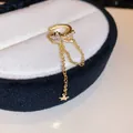 Detailed macro view of gold-toned star tassel ear cuff with sparkling zircon - Star Tassel Style (10#) / Single Piece / Gold