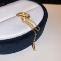 Close-up of gold tassel ear cuff featuring sparkling zircons and a geometric pendant - Flower Tassel Style (1#) / Single Piece / Gold