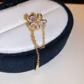 Detailed view of a gold flower ear cuff with sparkling zircons and hanging tassel chain. - Flower Style (2#) / Single Piece / Gold