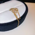 Close-up of gold zircon leaf ear cuff with dangling tassel chains on jewelry box - Leaf Style (9#) / Single Piece / Gold