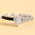 Close-up detail of a silver heart ring with black enamel and clear sparkling zircons. - Heart Zirconia Black Enamel Patchwork Style (6160) / White Gold Color (6160)