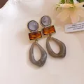 Close-up of vintage geometric acrylic earrings with amber and marble texture - Silver Earring Post Style / Purple Coffee and Gray