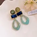 Detailed shot of vintage Maillard style geometric acrylic pendant earrings. - Silver Earring Post Style / Green and Blue