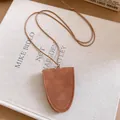 Minimalist brown leather glasses holder necklace detail with visible stitching on canvas - Shield Shape / Brown