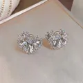 Close-up macro view of elegant sparkling pleated ear clips with oval zirconia stones. - Oval Pleated Style / Silver