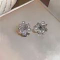 Detailed view of 18k gold plated clip-on earrings with stars, pearls and zircons. - Pearl Starburst Style / Silver