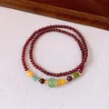 Detailed view of elegant double-strand garnet bracelet featuring vibrant gemstone accents - 8mm / Gold-Red-Multicolor