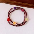 Close-up of a vintage garnet beaded bracelet with multi-colored gemstone accents - 8mm / Red-Multicolor