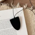 Detail of the minimalist black leather glasses holder necklace on a textured background - Minimalist Black Leather (Eyeglass Holder Necklace) / Necklace-Black