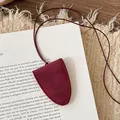 Close-up detail of a minimalist red leather eyewear holder necklace pendant on white card - Wine Red Stitched (Eyeglass Holder Necklace) / Necklace-Red