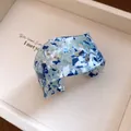 Chic blue and white marbled acrylic cuff bracelet featuring elegant floral cut-out patterns - Blue