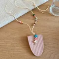 Detailed view of the pink leather glasses bag necklace with colorful starfish charms. - Necklace / Pink
