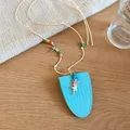 Close-up of a light blue leather glasses bag necklace featuring colorful beads and starfish charms - Necklace / Sky Blue