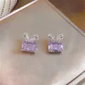 Close-up of elegant purple zircon stud earrings with a sparkling bowknot design - Silver Earring Post - Purple