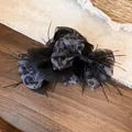 Close-up of leopard print fabric bow hair claw clip with elegant black feathers - Bow Claw Clip / Grey Leopard