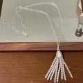 Detailed view of a vintage Bohemian pearl tassel sweater chain necklace with silver chain - Silver