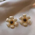 Detailed view of French vintage enamel flower earrings with creamy white petals and gold core - Flower Shape / White (Gold Edge)