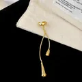 Detail view of a golden water drop tassel ear cuff with elegant vintage niche design. - Ear Clip (Gold) / Single Piece