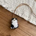 Handmade embroidered fabric cat pendant necklace with brown leather rope on wooden background - Necklace-Brown-Black-White