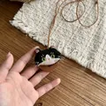 Detailed view of a cute handmade fabric cat pendant necklace on a leather cord. - Necklace-Coffee-Black