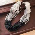 Close-up of multi-strand beaded necklace with black, silver, and white seed beads. - Necklace-White-Gray-Black
