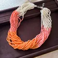 Close-up of multi-strand beaded necklace with white, pink, and orange gradient - Necklace-White-Pink-Orange
