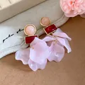 Detailed view of pink acrylic petal earrings with red and peach geometric resin studs - Pink