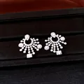Detailed macro view of elegant silver-toned chandelier earrings set with cubic zirconia stones. - Stud Earrings / Silver