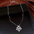 Detail shot of elegant silver snowflake pendant necklace with sparkling zirconia stones - Necklace / Silver