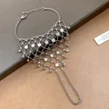 Close-up of silver hollow mesh hand harness with tassel and sunburst disc details. - Sun Pattern Disc Style (Style 6)