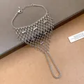 Detailed macro view of silver hollow mesh tassel ring-bracelet integrated hand chain. - Bohemian Style (Style 8)