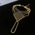 Detailed view of intricate gold hollow lattice ring bracelet integrated chain jewelry - Style 9