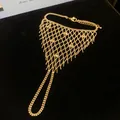 Detail view of gold hollow mesh tassel ring-bracelet integrated hand harness jewelry - Style 7