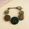 Close-up of vintage resin bracelet with green drip-oil flower and leaf patterns. - Gold-Silver-Green