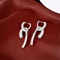 Detailed macro view of 18k gold plated drop earrings with sparkling cubic zirconia stones - Hoop Earrings-Silver-18K Gold Plated