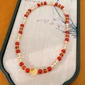 Vista detallada de una pulsera de cuentas rojas y ámbar con piedra ojo de tigre - 5# Pulsera
